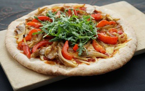 Pizza with mushrooms, paprika and arugula leaves