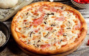 Tasty pizza with mushrooms, sausage and cheese