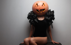 Halloween girl with pumpkin on her head