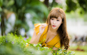 Asian girl in a yellow dress in the park