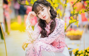 Beautiful Asian girl in a beautiful pink outfit in the park