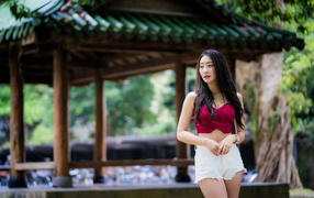 Beautiful girl in white shorts in a park