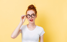 Красивая девушка в очках на желтом фоне 