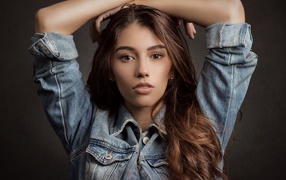 Beautiful long-haired brown-haired woman in a denim jacket