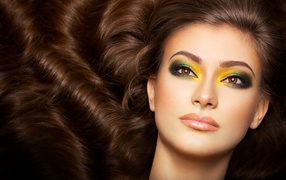 Beautiful long-haired girl with bright makeup on her eyes