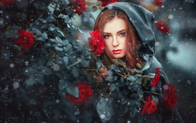 Девушка в черном плаще у  куста роз 
