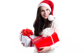 Smiling girl in santa hat with gifts on white background