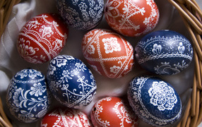 Colored eggs with a beautiful pattern in a basket for Easter