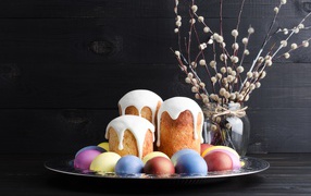 Delicious Easter cakes on a tray with eggs and willow branches for Easter