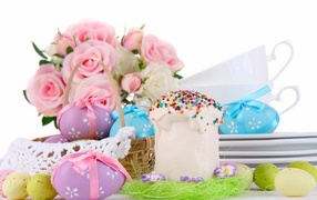 Easter cake, colored eggs and flowers for the holiday