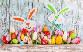 Tulips, colored eggs and hares decor for Easter holiday