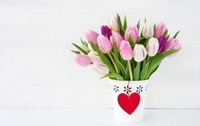 Bouquet of tulips in a vase and a heart for a loved one