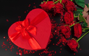 A large heart-shaped gift with a bouquet of roses for a loved one