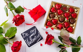 Box of chocolates with rose flowers and a gift for Valentine's Day