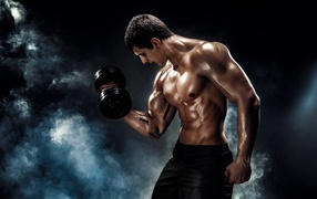 Мужчина тяжелоатлет с гантелей в руке