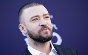 Лицо голубоглазого актера Джастина Тимберлейка на синем фоне