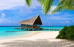Stilt house by the tropical white sand beach