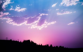 Beautiful lilac sky with bright rays of the sun