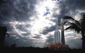 A rocket prepares to launch against a stormy sky