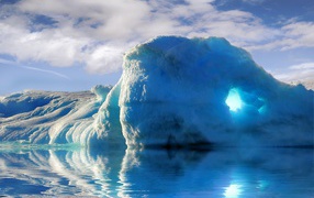 Big blue iceberg in water