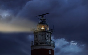 Stormy sky over the included lighthouse at night
