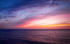 Beautiful pink sunset in the sky over a quiet sea