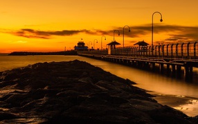 Long bridge on the sea at sunset