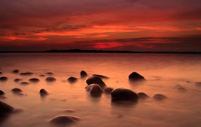 Stones in the river water at sunset