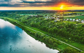 Sunset over the city by the river, aerial view