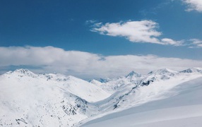 Красивый вид на заснеженные горы под голубым небом 