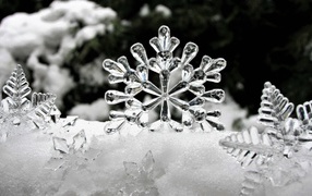 Стеклянные снежинки лежат на снегу