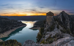 View of an old temple on a cliff top above a river, Spain