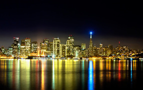The beautiful night city of San Francisco is reflected in the water