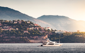 White yacht in the sea against the background of the city of Monte Carlo, Monaco