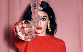 American actress Lucy Hale with a glass of water