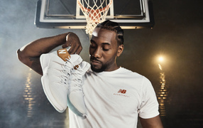 American basketball player Kawai Leonard with sneakers in his hand