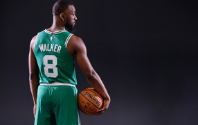 American basketball player Kemba Walker in uniform with the ball