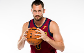 American basketball player Kevin Love with a ball in his hands on a white background