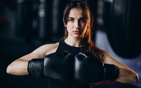 Boxer girl with black gloves on her hands