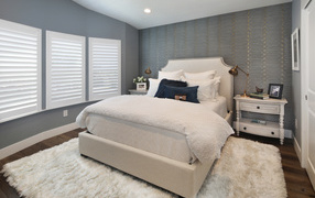 High bed in a bedroom in gray tones