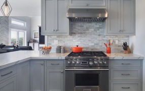 Large gas stove in a gray kitchen
