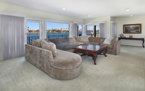 Большой диван и стол в просторной гостиной 