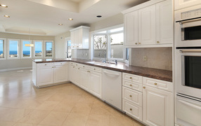 Large white kitchen with windows