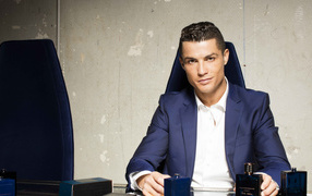 Stylish man, soccer player Cristiano Ronaldo with perfume at the table
