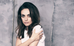 Нежная девушка, актриса Мила Кунис на сером фоне