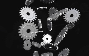 Металлические шестеренки в воздухе на черном фоне