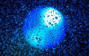 Round blue ball in water with bubbles