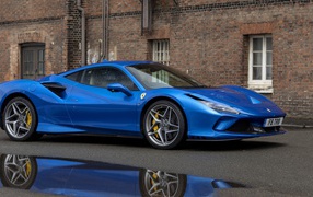 Blue Ferrari F8 Tributo car in front of the building