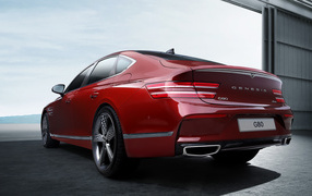 Красный автомобиль Genesis G80 Sport 2021 года вид сзади