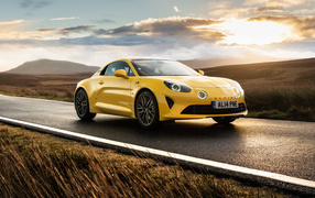 Желтый автомобиль Alpine A110, 2021 года на фоне заката